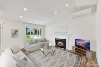 Living room with vaulted ceilings and fireplace.