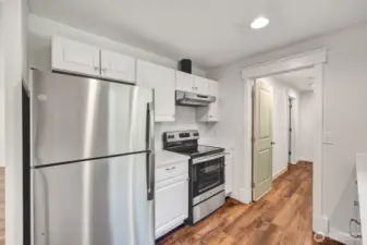 Updated kitchen with quartz counter tops, new cabinets and stainless steel appliances.