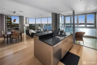 Large Kitchen island with raised bar includes a Stainless sink, filtered hot & cold water, SS dishwasher and trash compactor