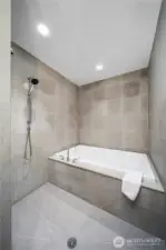 Large wet room with bathtub and spacious shower