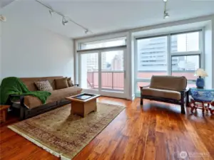 Living room with an abundance of natural light opens to private balcony.