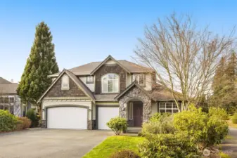 Cedar shakes and stone accents give this home dramatic curb appeal. Did you notice the 3-car garage?
