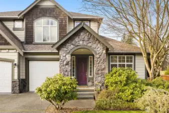 A covered front porch protects guests and packages from the elements.