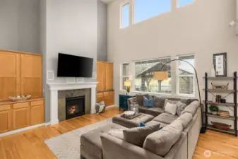 Clerestory windows drench this space in natural light. Gas fireplace adds cozy vibes at the flip of a switch.