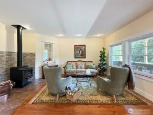 Living Room with Gorgeous Wood Floors and a Wood Burning Stove