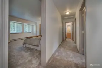 Upstairs hallway & primary bedroom to the left