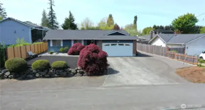 Additional parking in the front of the bushes and on the side of the home.