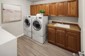 Extra large laundry room on the upper level loaded with storage.