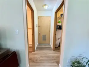 From family room; left door is the half bathroom, forward door is the garage, and right door is the laundry/utility room.
