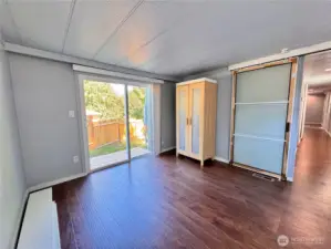 Bedroom #1 with a slider out to a small deck. Barn door.