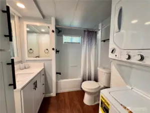 Updated bath complete with a stackable laundry set.