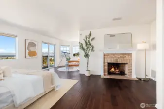 Welcome in through double doors to the primary suite. Gas fireplace with beautiful brick surround and wood mantle.