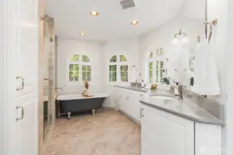 Updated primary bath. Clawfoot tub is the focal point. Heated floors, quartz counters. Shower has two chrome showerheads and view of Mt. Rainier from the tiny window.