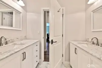 Full bath with two sinks/vanities. This bathroom is located in the hallway next to the 2nd bedroom and two flex rooms.