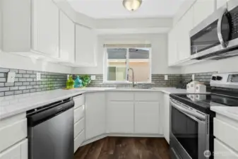Quartz Countertop and Glass Tile Backsplash. SS Appliance.