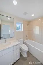 Main Bathroom with tile surround and tub/shower