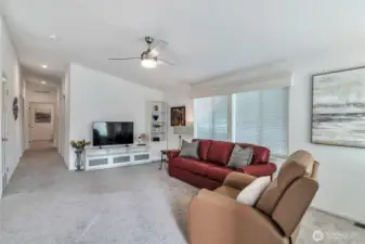 Vaulted ceilings contribute to spacious feel in concert with natural window light, recessed lighting, and fresh and bright palette throughout.