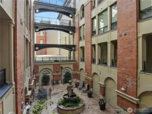 View from the Unit door.  Enjoy the open air Courtyard.  Relax by the water fountain with a good book or visit with other residents.   Lush well cared for plantings AND summer monthly concerts right out the front door to the unit!