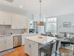 Staged view of Upgraded kitchen w/extended island that seats 4. Staged prior to Seller move out.