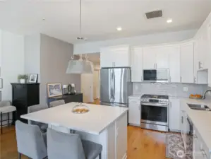Staged view of the upgraded kitchen and appliances all stay.