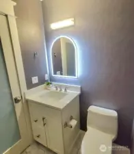 1/2 bath, designer wall paper & newly installed lighted mirror