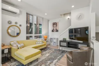 Living area with big windows and custom shades.