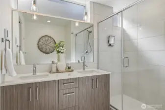 Spa-like bathroom with double sink vanity and natural light
