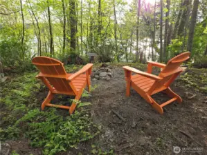 In winter, enjoy partial water and sunset views from the naturally cleared level area.  In the summer, the follage obscures the views and offers more privacy.