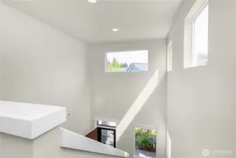 Lots of natural light fills the entry and stairway, creating a cheerful, inviting space.