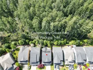 An overview of the home, green belt, and fenced back yard space.