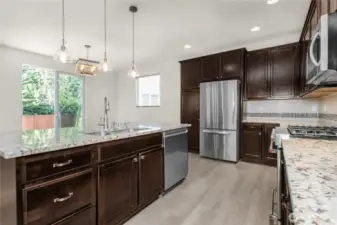 Prepare meals while staying connected to guests in the dining room and the beauty of the backyard beyond.