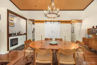 Dining room offers easy access to the kitchen and features a barn door entry to the laundry area.