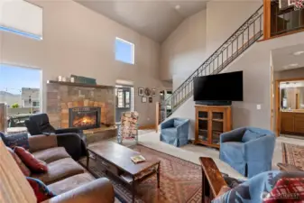 Foyer with open floor plan to dining and living room with fireplace