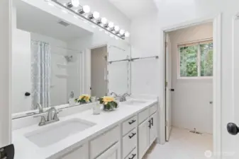 Bathroom 2 with dual sink vanity and tub/shower combo.