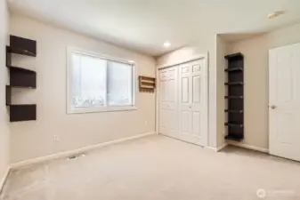 Built-in shelving and large windows are an extra bonus in this bedroom.