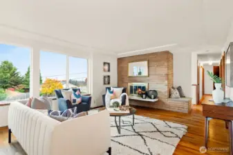 Living room with fireplace and hardwood floors.