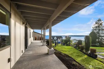 Covered walkways flowing into the grounds... an ideal place for planters, benches and sitting areas. Add a fence to increase privacy on the west side.