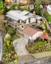 Cool aerial view of the home & its 2-car garage with tall ceilings + shop.