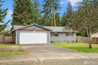 Two car garage & spacious driveway with additional parking space on side yard of home.