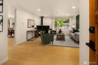Front door opening into living room with seamless flow into kitchen.