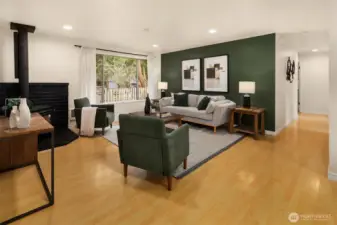 Living room with hallway connecting to bedrooms & bathrooms.