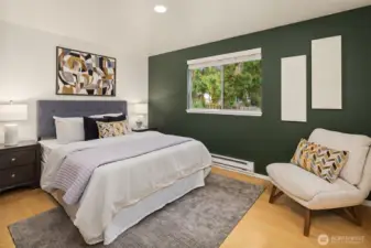 Primary bedroom with large window.