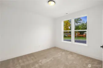 This flexible main-level bedroom, den, or office offers soft carpeting, a peaceful backyard outlook, and easy access to the full bath. Ideal for guests, multigenerational living, or a private home office—whichever best fits your lifestyle.    These photos are from lot 3 at Gooden Hollow, the actual home for sale. However, other homes may vary, so all photos, renderings, site maps, and floorplans are for visualization purposes only. Plans, colors, building orientation, finishes, home outlook, and other details can and WILL vary.