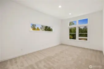 This open bonus loft on the upper level offers a bright, flexible space ideal for a media area, play zone, or secondary lounge. Large windows bring in natural light and frame neighborhood views, making it an easy place to gather, work, or unwind.    These photos are from lot 3 at Gooden Hollow, the actual home for sale. However, other homes may vary, so all photos, renderings, site maps, and floorplans are for visualization purposes only. Plans, colors, building orientation, finishes, home outlook, and other details can and WILL vary.