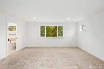 This spacious and light-filled suite offers a serene retreat with large windows overlooking lush greenery for added privacy and calm. Its generous layout easily accommodates a variety of furniture configurations, creating a restful space to unwind at the end of the day.    These photos are from lot 3 at Gooden Hollow, the actual home for sale. However, other homes may vary, so all photos, renderings, site maps, and floorplans are for visualization purposes only. Plans, colors, building orientation, finishes, home outlook, and other details can and WILL vary.