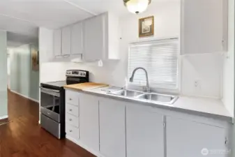 The kitchen window faces East. There are plenty of cabinets for storage.