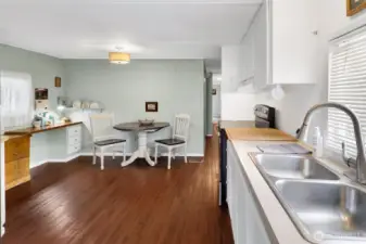 Kitchen with eating area and a convenient little built in desk and shelf.