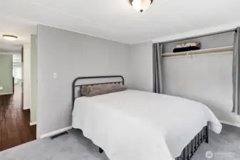 Main bedroom with big closet with curtains. This also hides a panel to access the hot water heater.