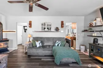 Enter to laminate hardwood floors and a spacious living room.