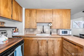 The U shaped kitchen allows you to be in the center of preparing meals while a small eat in bar hosts guests.